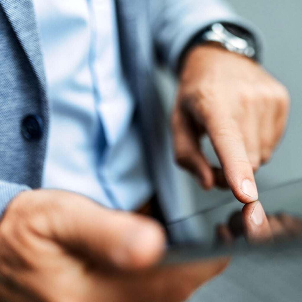 Man tapping a digital device