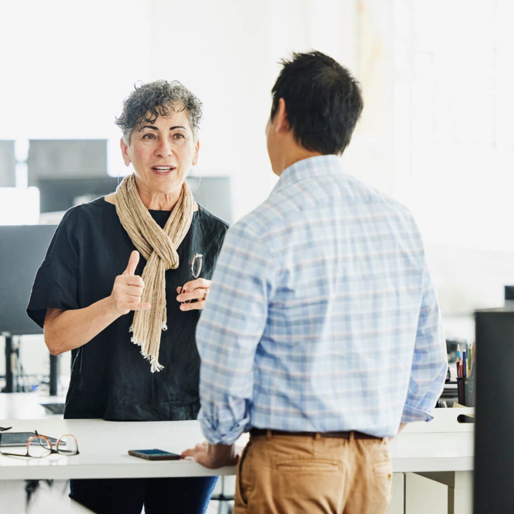 Two people speaking at table