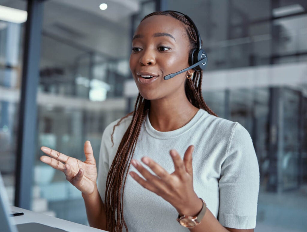 Woman engaging in a conversation at work wearing a headset